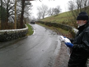 Steve navigating with a SplashMap through hammering rain in Lake District